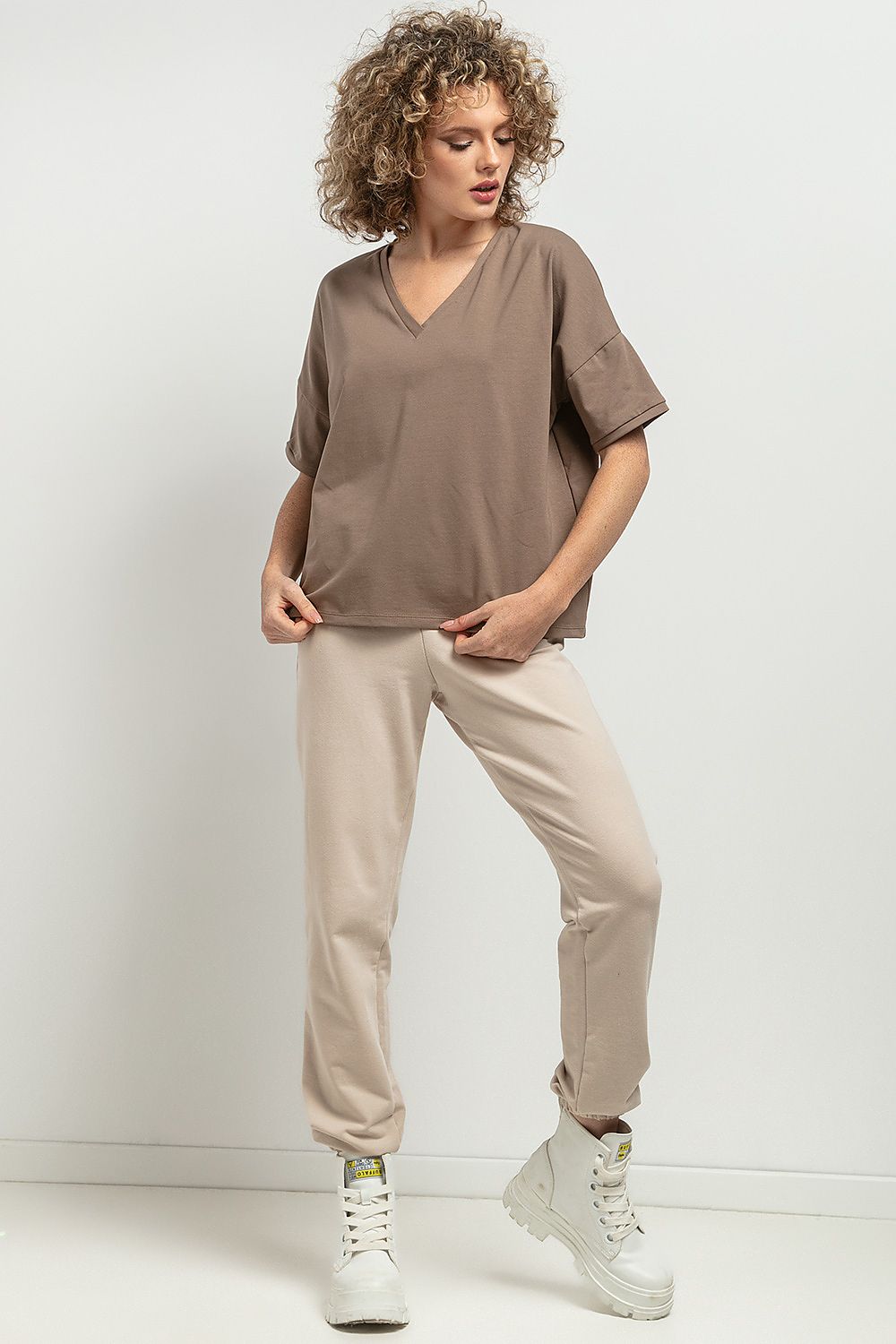 Tessita Loose Blouse in a chic striped pattern, demonstrating versatility for outdoor wear or elegant tucking into skirts or pants.
