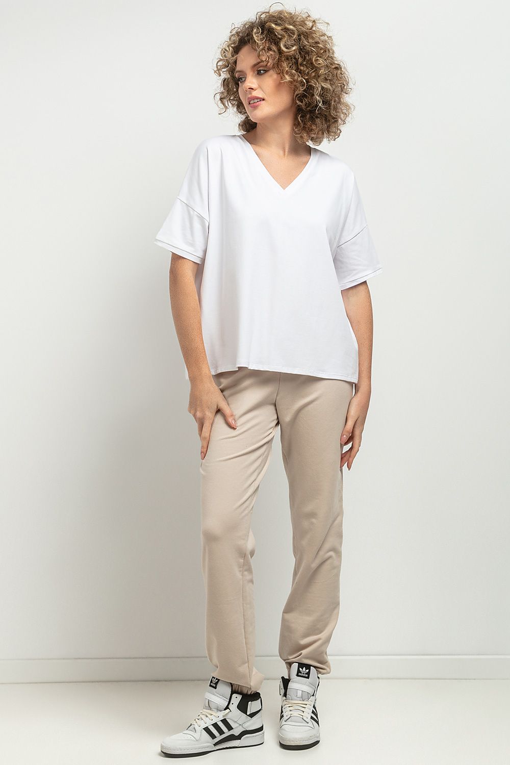 Tessita Luxurious Loose Blouse featuring a feminine V neckline with elegant decorative pleats and an exquisite striped design, crafted from high-quality knitted cotton.