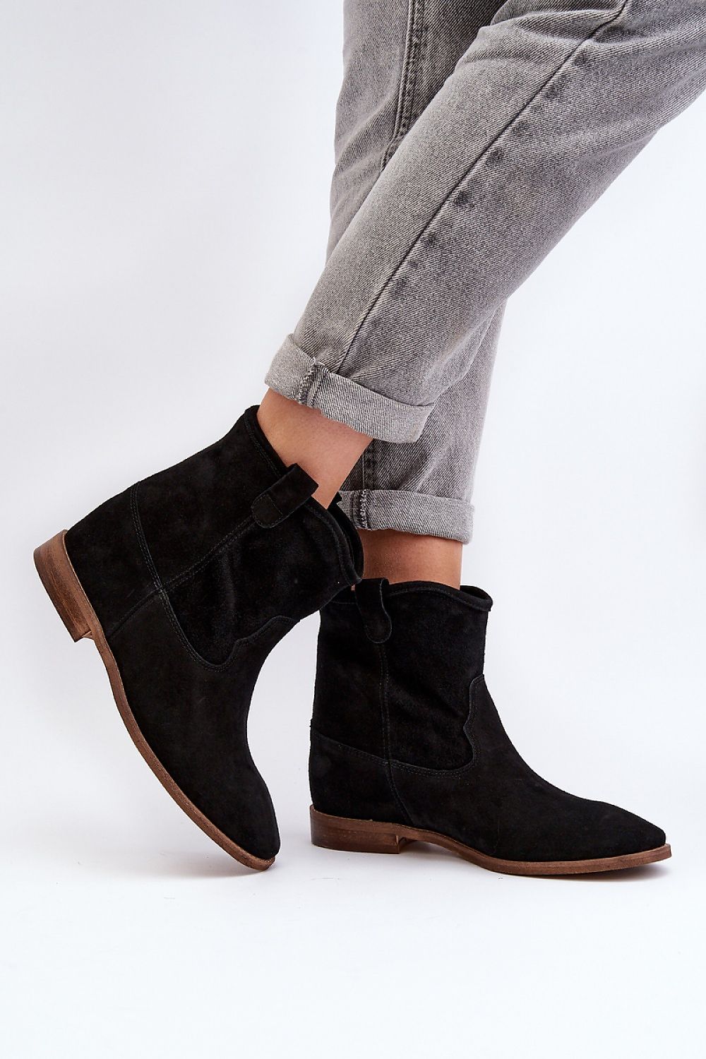 Elegant luxury women's suede boots featuring a classic tapered fit and flat heel, designed by Step in Style with a comfortable natural leather insole.