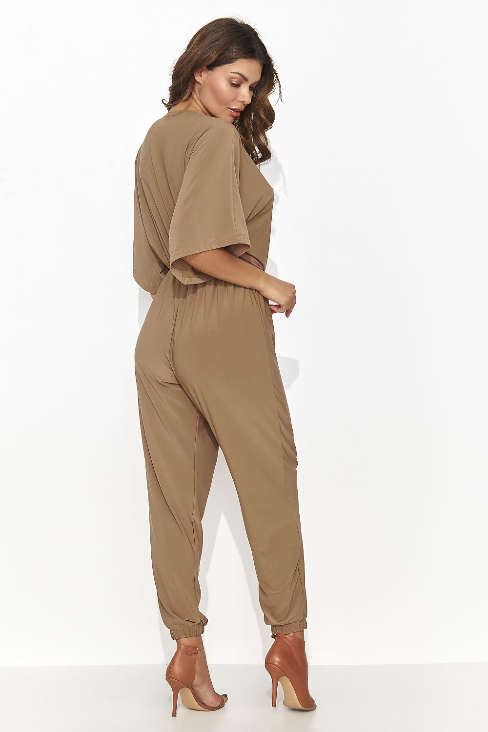 Luxurious women's jumpsuit by Numinou in a soft pastel pink, designed with a heart-shaped neckline and flowing fabric for a chic yet comfortable fit.