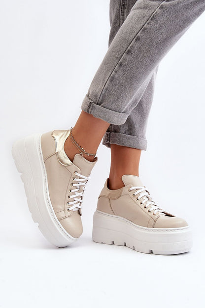 Chic beige women's natural leather sports shoes by Step in Style with a striking massive platform, displayed on a model's feet while wearing casual grey jeans, perfect for everyday fashion.