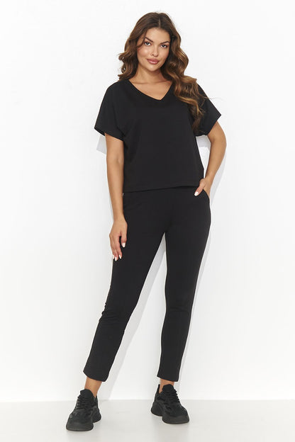 Elegant Numinou knitted ensemble featuring an oversized shirt and long tube pants, showcasing luxurious comfort with side pockets, perfect for confident women.