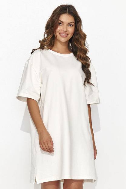 Elegant Numinou short tracksuit dress featuring a modern design with subtle back cutout and gold accent, perfect for casual chic gatherings.