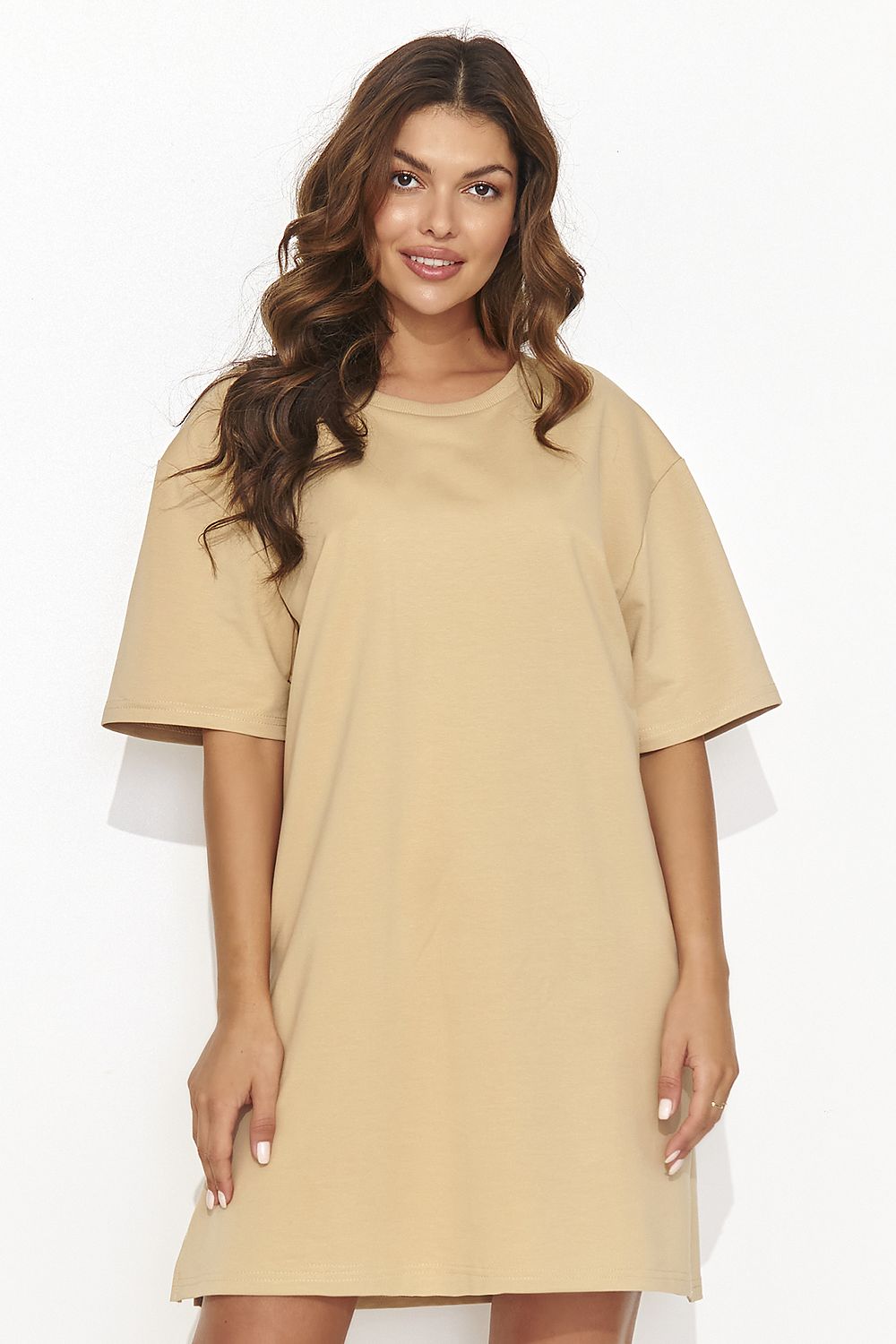 Modern Numinou tracksuit dress adorned with gold-tinted jewelry, exemplifying a contemporary and fashionable approach to casual wear.