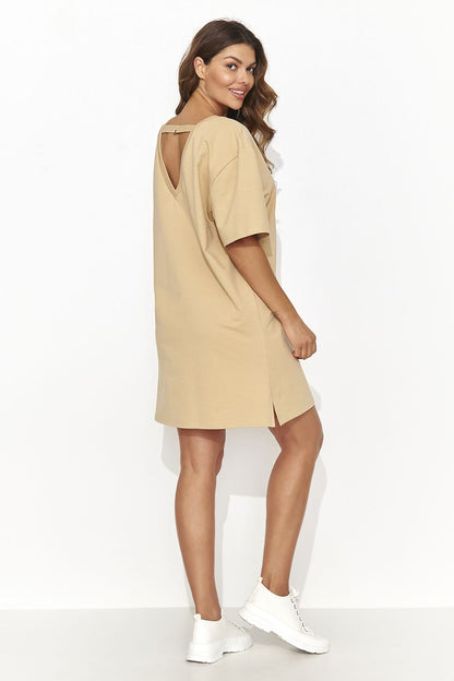 Numinou luxurious modern short tracksuit dress featuring a subtle cutout at the back and gold accent detailing, perfect for casual yet stylish gatherings.