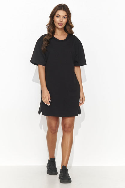 Luxurious Numinou modern short tracksuit dress showcasing subtle cutout and gold accents, elegant design for casual gatherings.