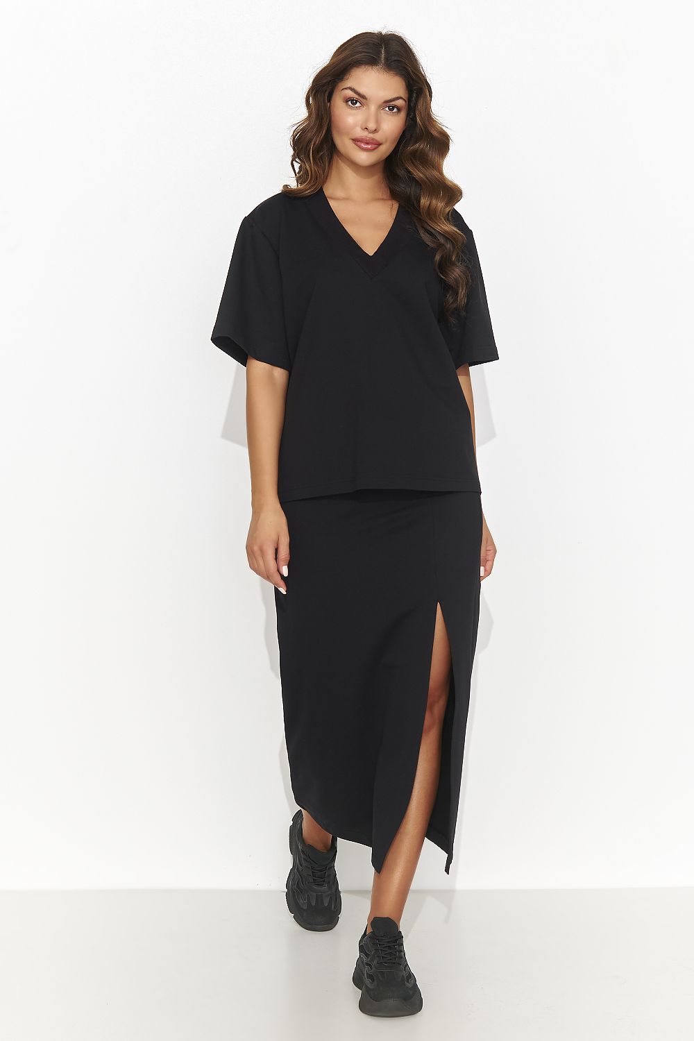 Luxury women's outfit by Numinou, displaying a chic knee-length pencil skirt paired with a sophisticated heart neckline blouse in a stylish setting.