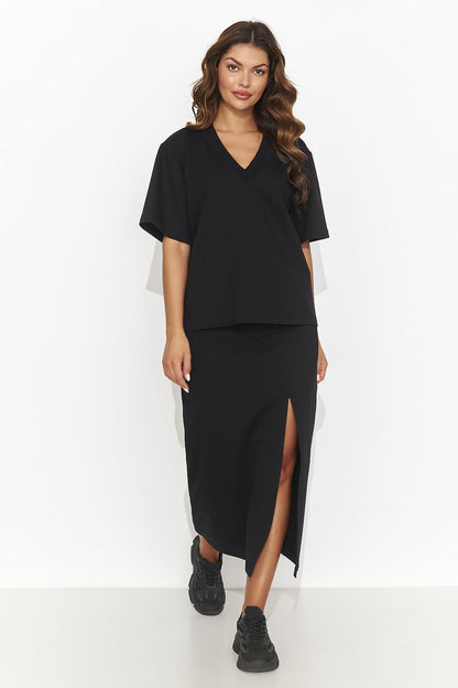 Luxury women's outfit by Numinou, displaying a chic knee-length pencil skirt paired with a sophisticated heart neckline blouse in a stylish setting.