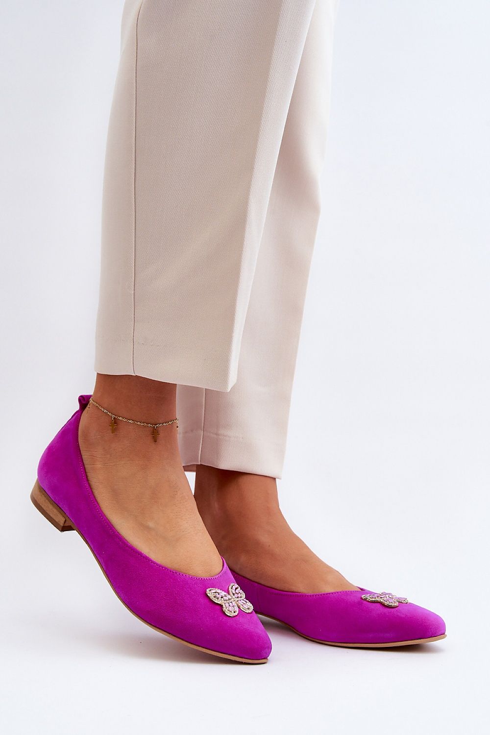 Stylish ballet flats with a decorative butterfly from Step in Style, perfect for a luxurious outfit.