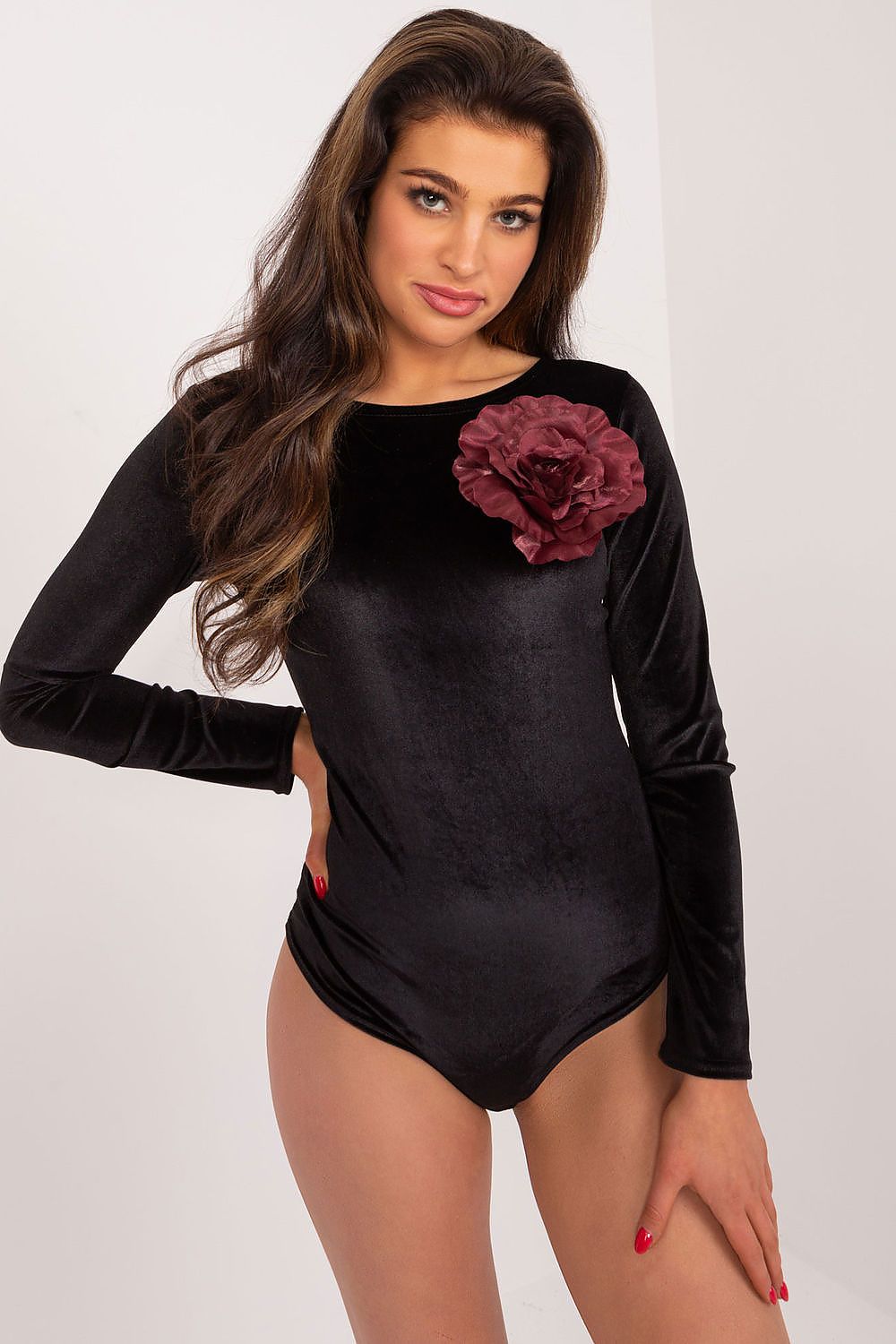 Model wearing Lakerta elegant bodysuit with long sleeves, demonstrating versatile styling options for luxury occasions.