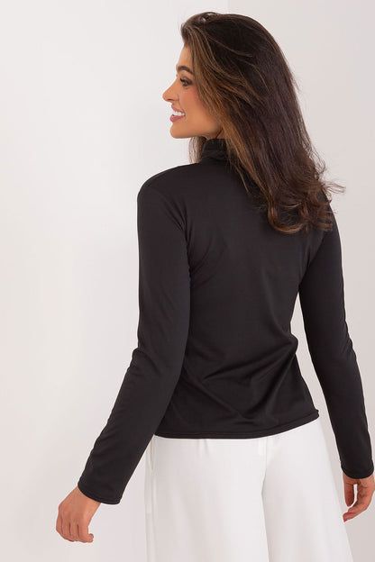 Close-up detail of Lakerta's fitted women's blouse in soft cotton, showcasing its sophisticated turtleneck design and rich fabric texture.