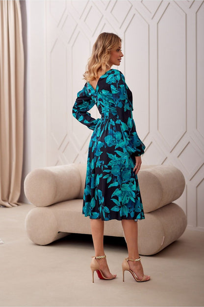 Close-up of Roco Fashion cocktail dress details showcasing exquisite fabric and elegant long sleeves.