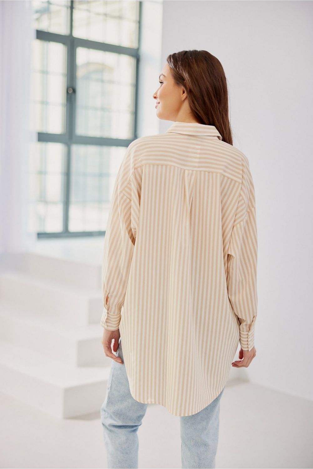Chic Roco Fashion women's striped shirt with a unique asymmetrical design, highlighting the perfect balance of comfort and luxury.