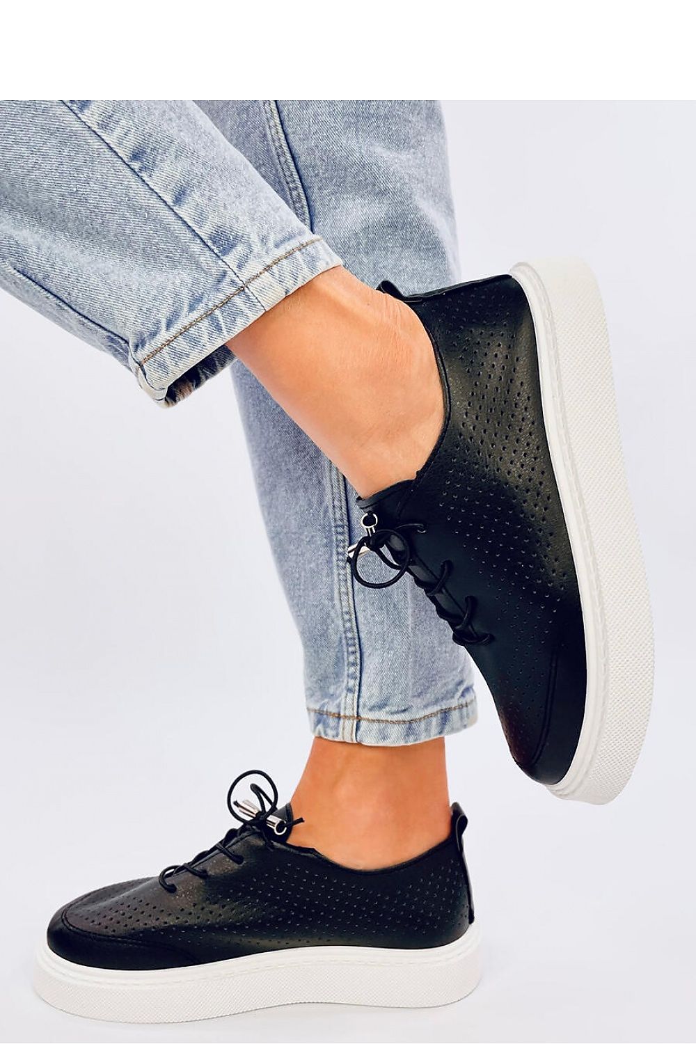 Side view of luxurious women's sneakers by Inello made from soft eco leather, showcasing a modern high sole for superior comfort and trendy fashion.