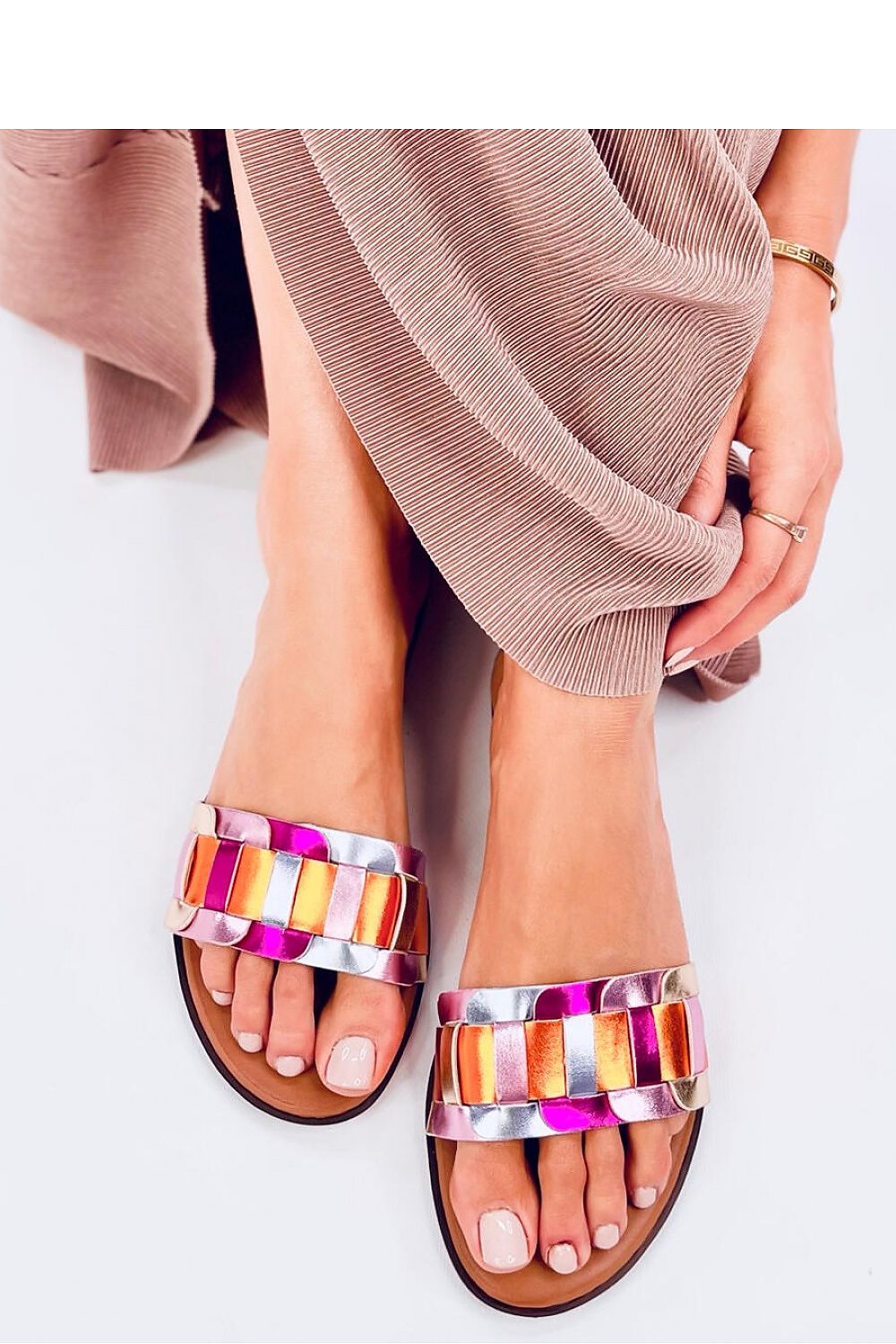 Elegant women's Inello braided strap flip-flops, showcasing a stylish summer look with colourful metallic detailing.