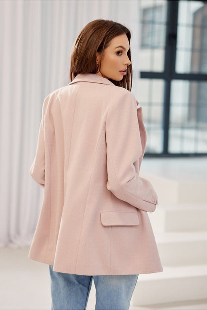 Elegant woman showcasing the back view of Freya Classic Blazer Jacket by Roco Fashion in soft pink herringbone fabric, featuring a flowing silhouette and tailored design.