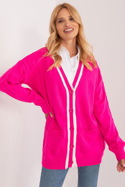 Stylish woman wearing an elegant Badu long sleeve cardigan in vibrant pink with contrasting white stripes, showcasing its button-down design and comfortable fit.