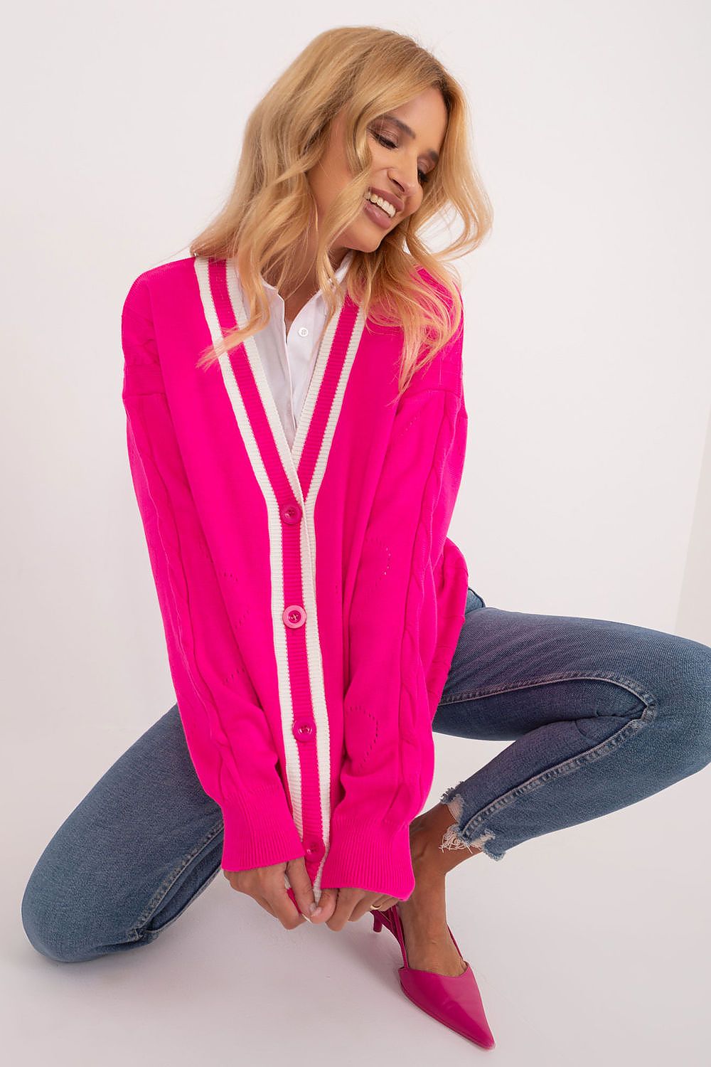Graceful pose of a woman in a trendy Badu long sleeve cardigan in eye-catching pink, demonstrating its chic style and versatility for various occasions.