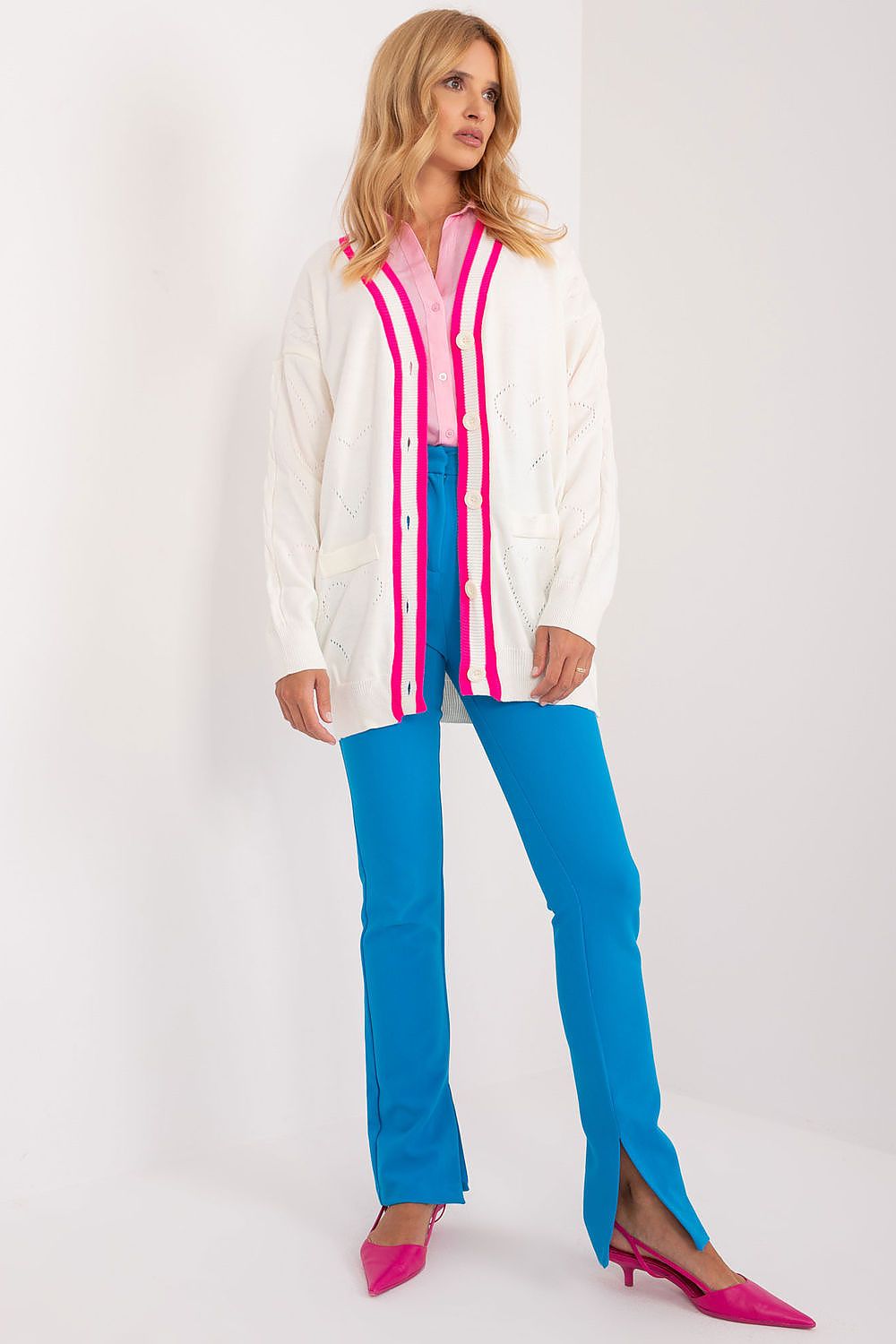 Elegant Badu long sleeve cardigan featuring contrasting stripes, styled with a pink blouse, set against a minimalist backdrop. A chic ensemble perfect for any occasion.