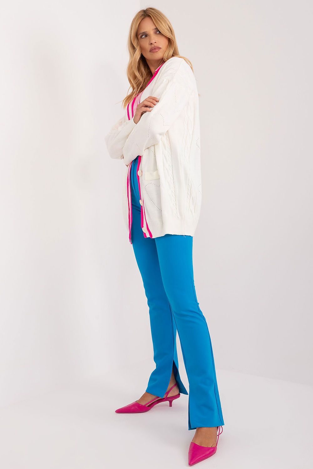 Stylish Badu long sleeve cardigan with bold contrasting stripes, complemented by striking blue trousers and pink heels, showcasing a trendy look suitable for modern women.