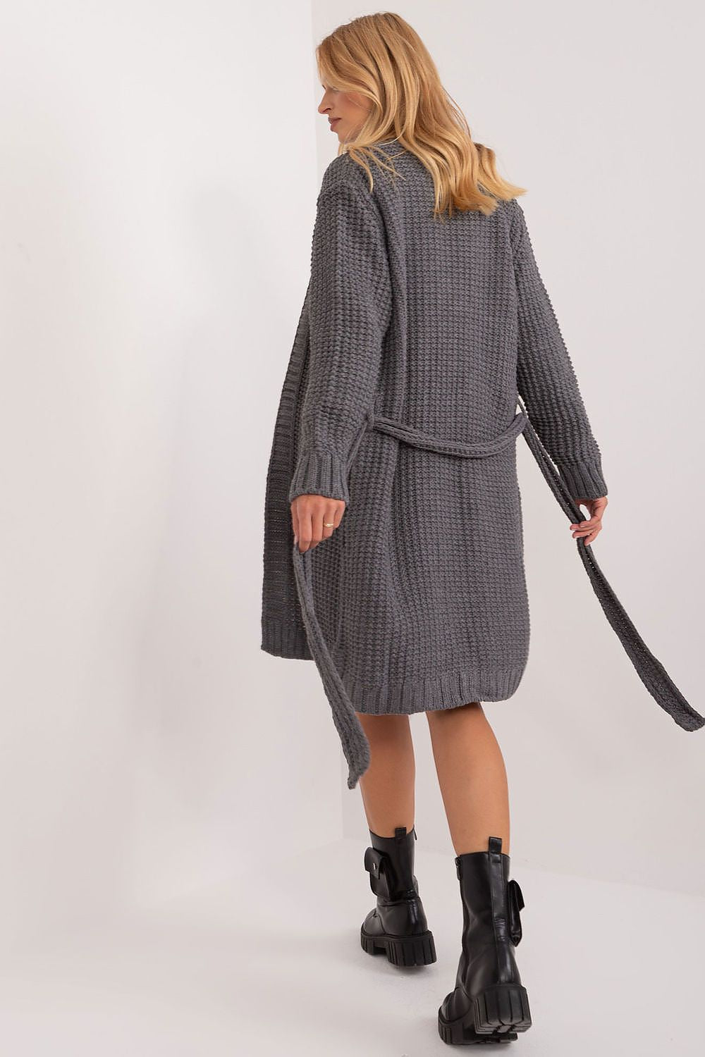 Chic back view of a luxurious grey cardigan with a tie belt by Badu, illustrating the fashionable long length and ample textured style.