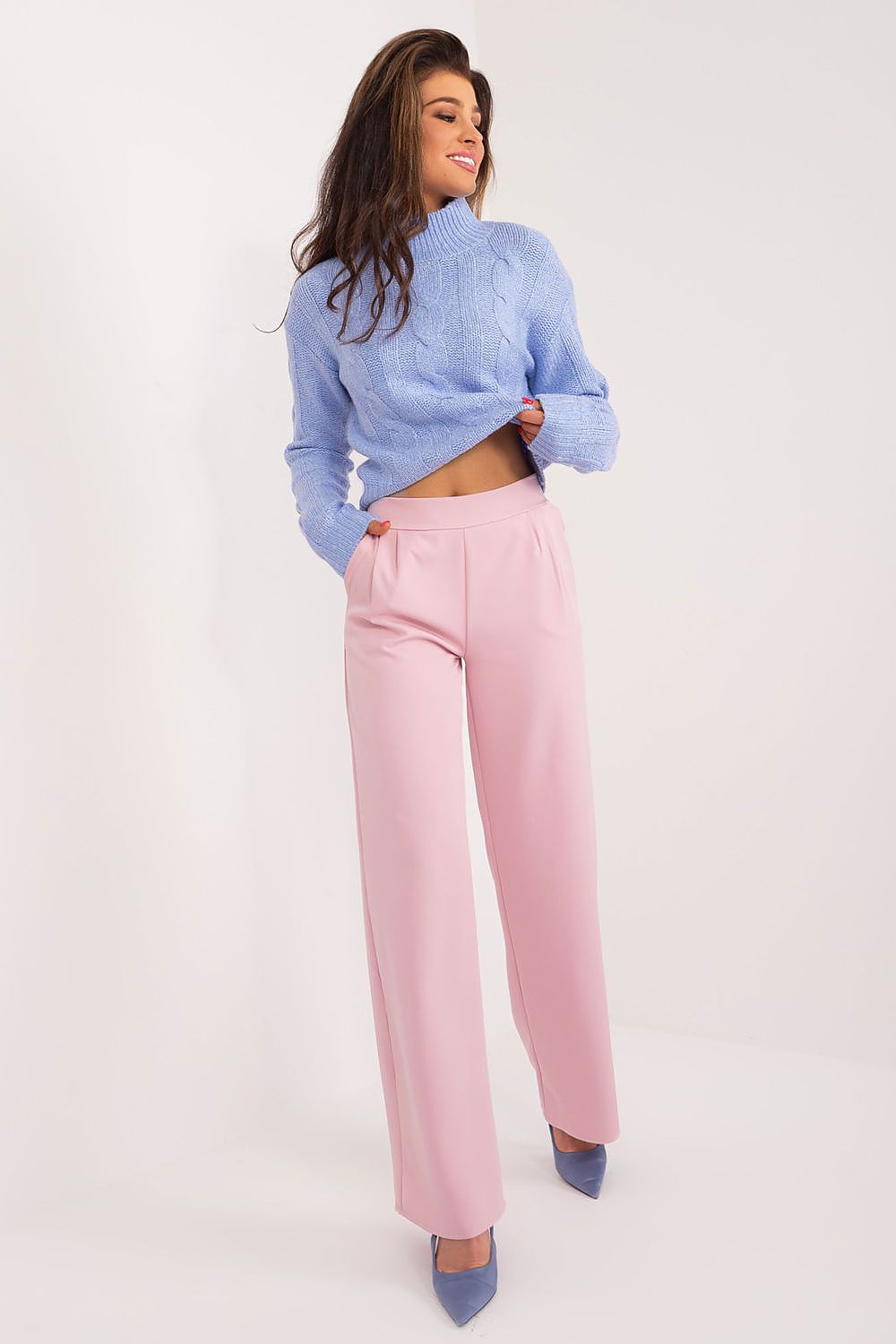 Elegant women's high waist trousers in soft pink, styled with a light blue knitted cropped jumper, showcasing a sophisticated and modern look by Rue Paris.