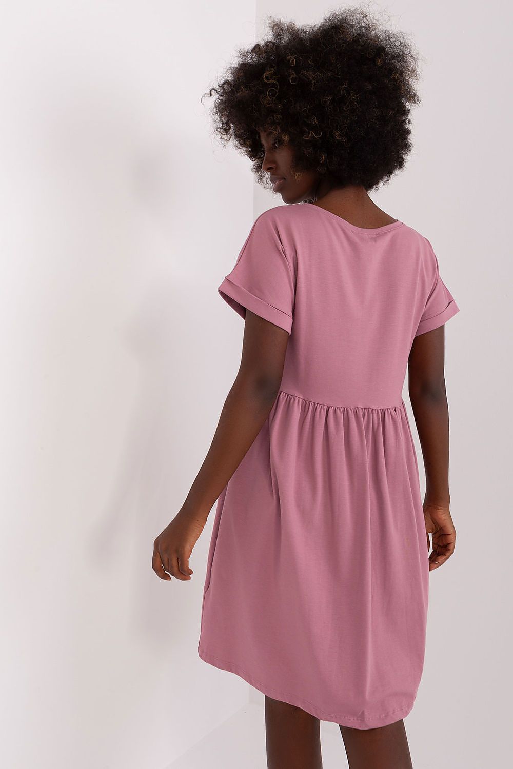 Back view of a Rue Paris flared cotton dress in blush pink, illustrating the beautiful design and comfortable fit, perfect for sophisticated everyday wear.