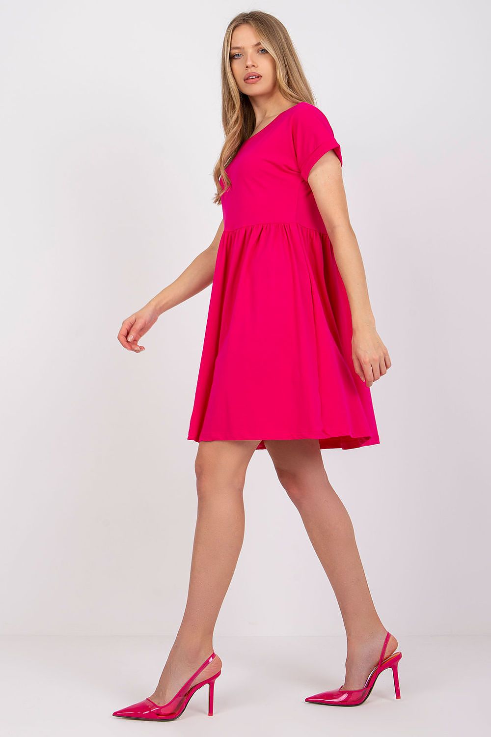 Side view of the luxurious Rue Paris flared cotton dress in pink, showcasing a flattering fit and playful flared skirt.