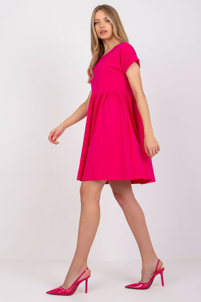 Side view of the luxurious Rue Paris flared cotton dress in pink, showcasing a flattering fit and playful flared skirt.