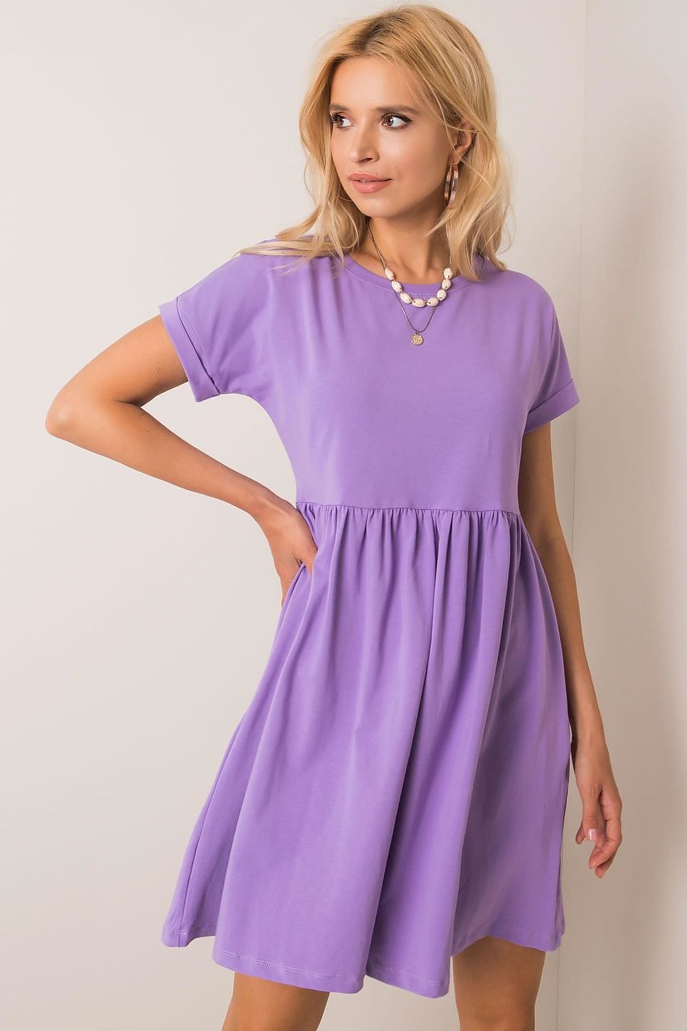 Beautiful model wearing a chic Rue Paris flared cotton dress in lavender, featuring short sleeves and feminine flair, perfect for casual elegance.
