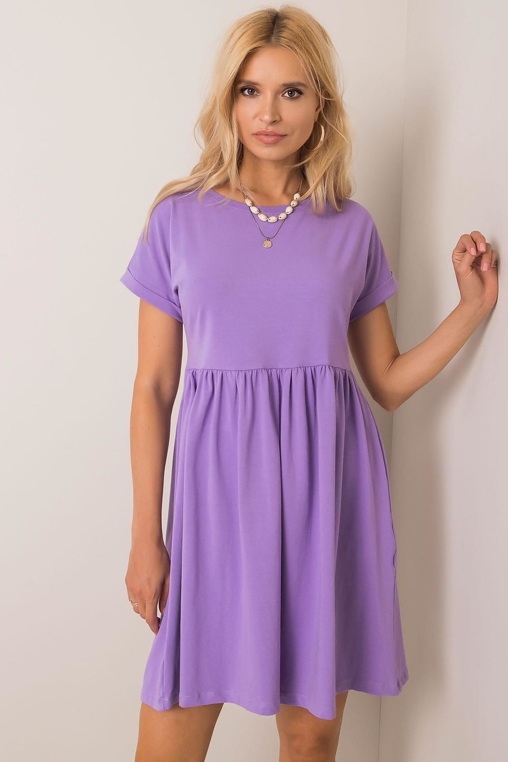 A chic light purple flared cotton dress with short sleeves, elegantly styled for everyday wear, showcased by Rue Paris.