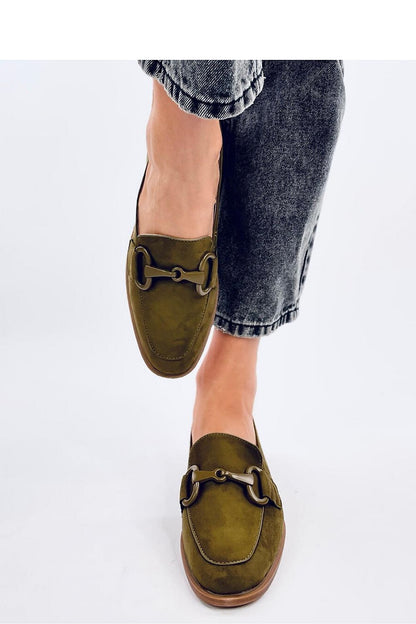 Trendy view of olive green moccasins by Inello, set against casual denim, highlighting their elegant design and versatile style for the modern woman.