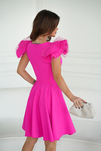 Back view of the Bicotone pink cocktail dress highlighting the unique shoulder design and flattering fit, suitable for stylish parties.