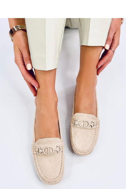 Fashionable women's suede moccasins with distinctive buckle detail, worn elegantly, highlighting comfort and style, designed by Inello.