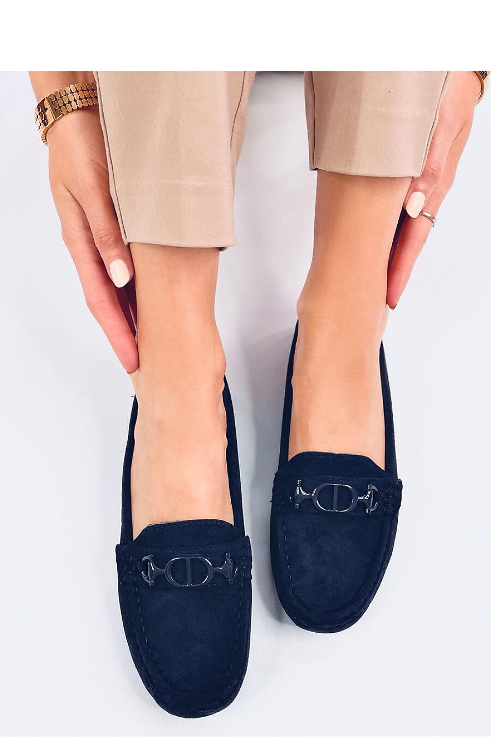 Stylish navy suede moccasins by Inello, worn by a model showcasing the shoe's sophisticated design and comfy fit.