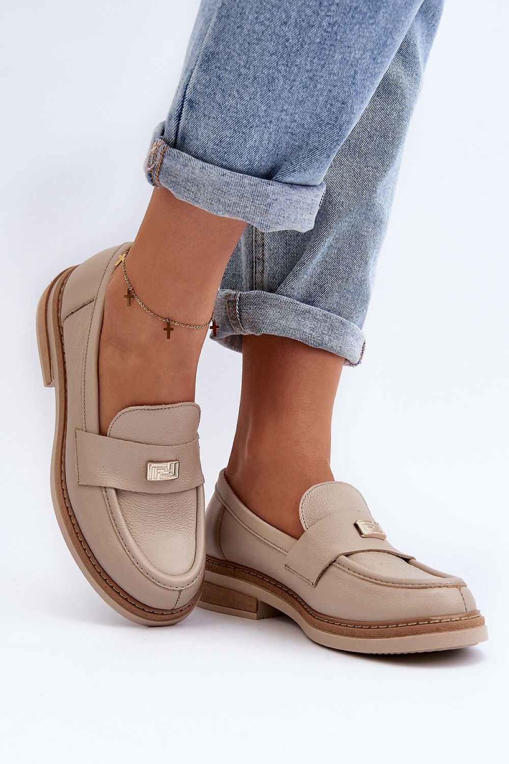 Stylish beige women's natural leather moccasins with padded heel counter, elegantly paired with rolled denim jeans, designed by Step in Style.