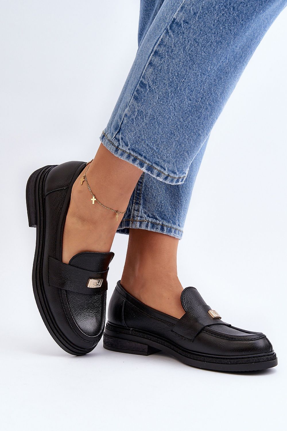 Sophisticated black leather moccasins for women, featuring a padded heel counter and decorative front, styled elegantly by Step in Style.