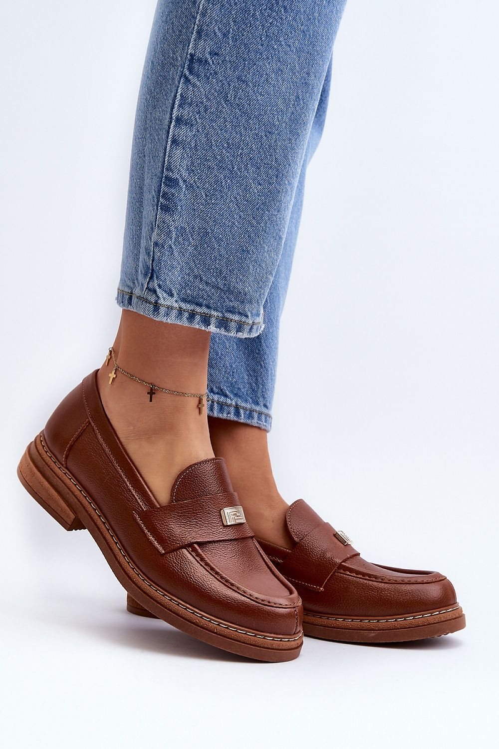 Elegant brown leather moccasins for women, designed with a padded heel and decorative detailing, showcased by Step in Style.