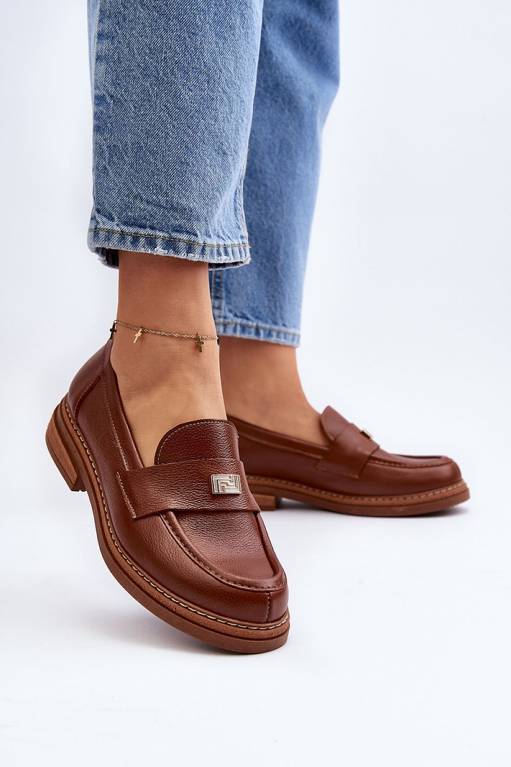 Stylish brown women's moccasins featuring luxurious leather construction and a refined front embellishment, available from Step in Style.