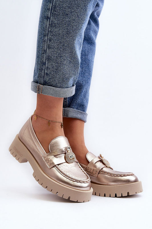 Elegant women's moccasins by Step in style, featuring a decorative strap and comfortable footbed, showcased in a stylish outfit with denim.