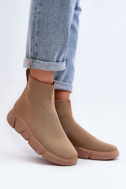 Stylish brown sock-style women's sports shoes by Step in Style, featuring a soft removable insole, showcased with rolled denim trousers.