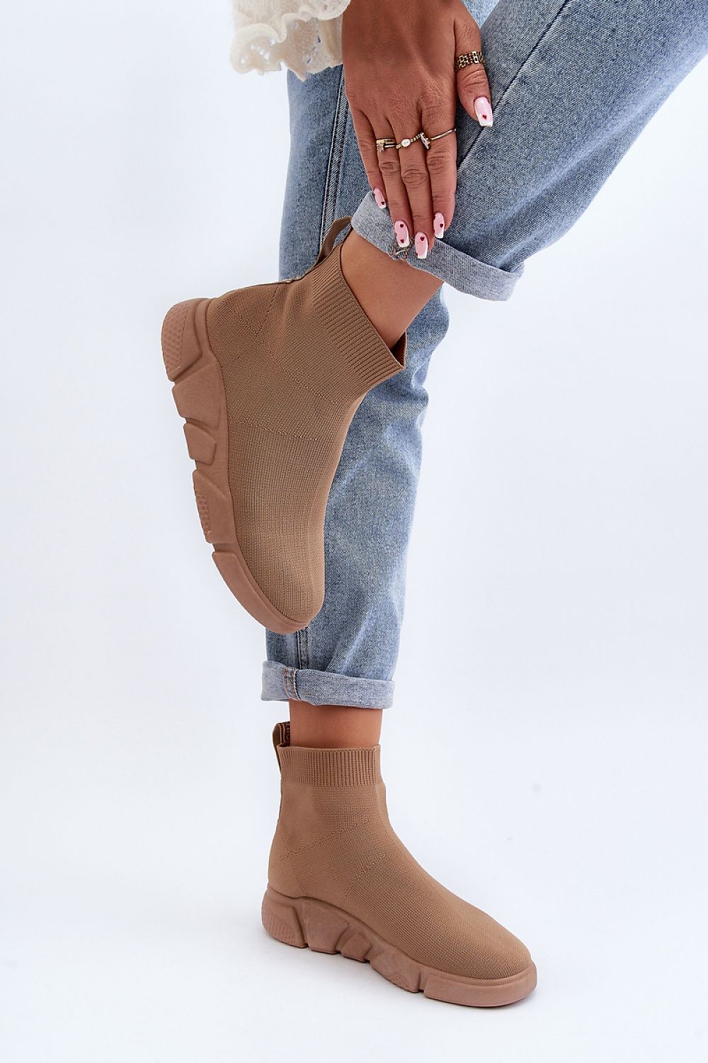 Elegant brown women's sports shoes with a sock-style upper by Step in Style, accentuated by a fashionable outfit and jewelry.