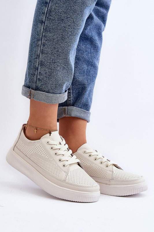 Elegant women's sports shoes from Step in Style, featuring a natural leather design and comfortable platform sole, styled with rolled denim jeans.