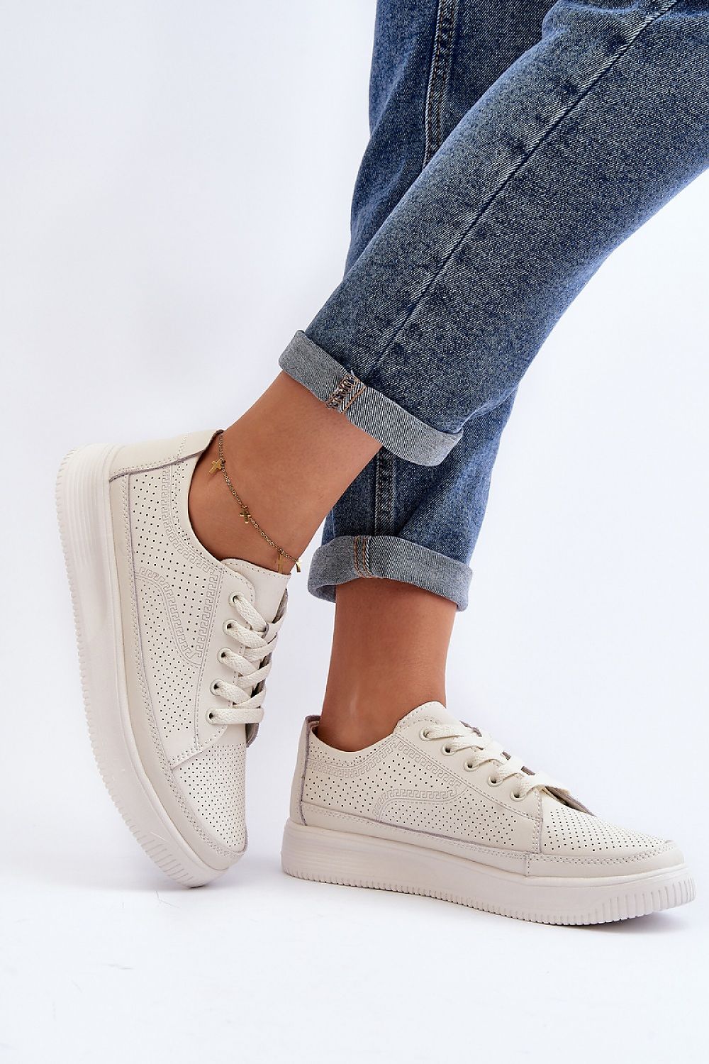 Chic women's sports shoes by Step in Style, crafted in natural leather with a stylish platform sole, elegantly displayed with cuffed denim trousers.