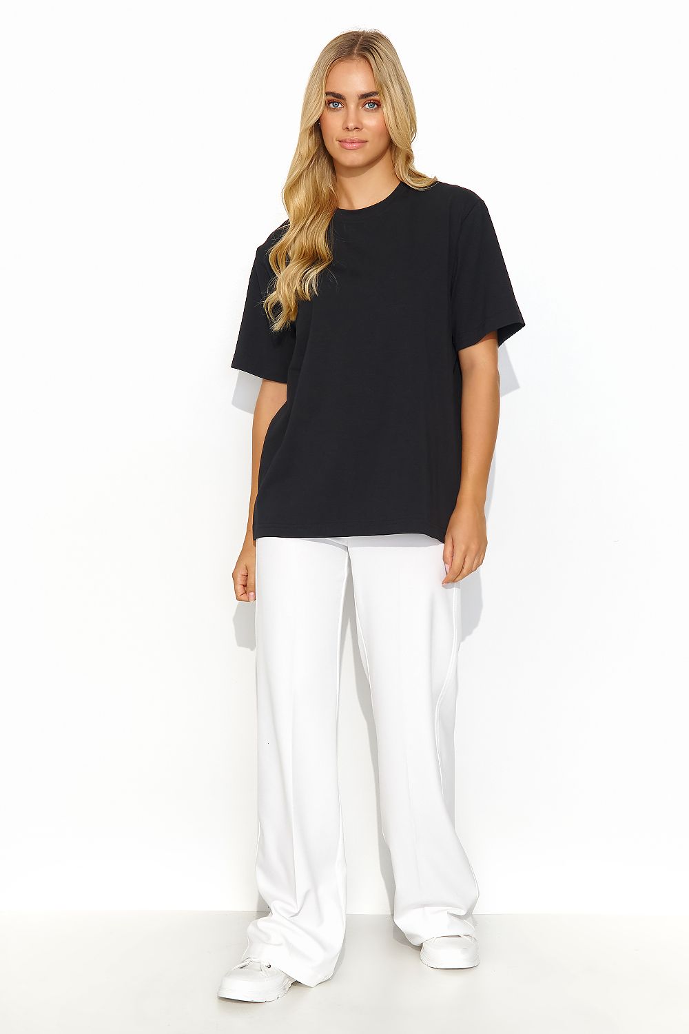 Luxurious Makadamia women's cotton blend t-shirt in black, featuring a casual fit with a smooth texture, styled with white tailored trousers for a sophisticated everyday look.