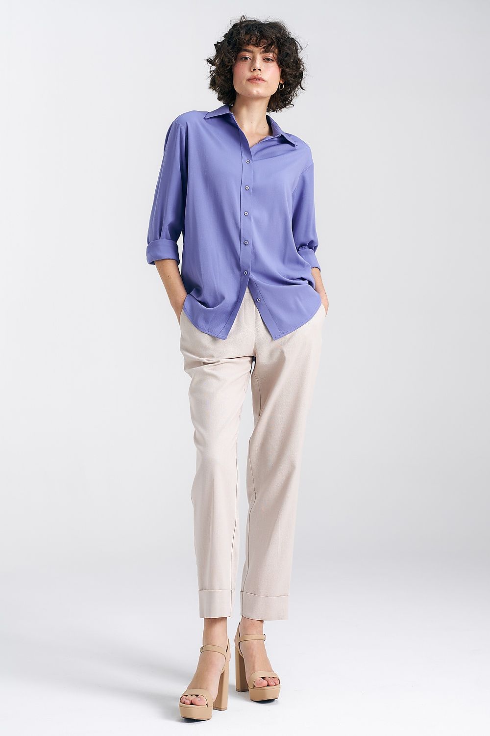 Elegant oversized long sleeve viscose shirt in lavender by Nife, featuring a classic collar and button closure, styled with cream trousers for a chic ensemble.