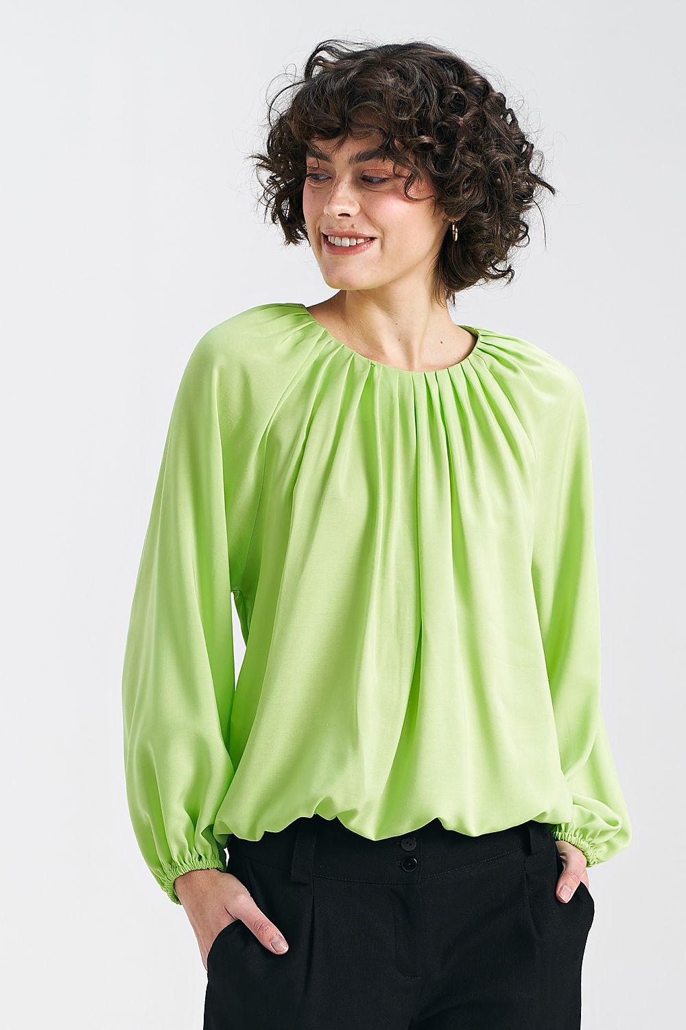 Lime viscose blouse by Nife featuring a pleated neckline and ruffled hem, styled with wide sleeves for a casual, elegant summer look.
