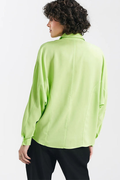 Back view of a luxurious lime oversize long sleeve shirt by Nife, highlighting its unique design and elegant silhouette.