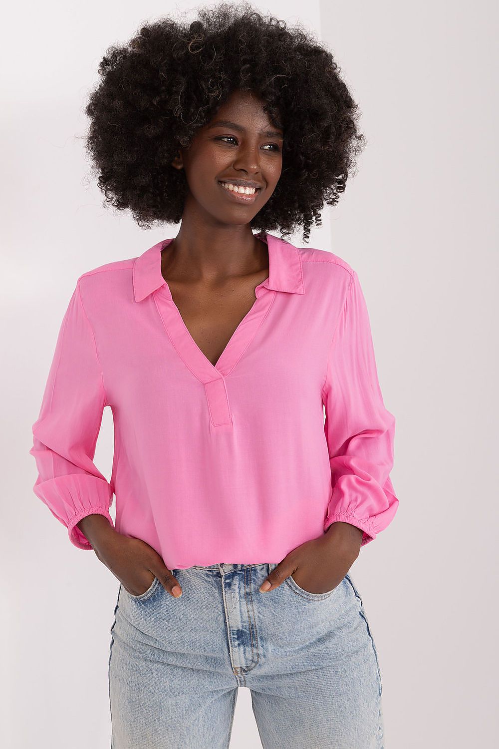 Elegant pink everyday blouse by Sublevel, featuring a heart neckline and pre-wrist sleeves, styled with light blue denim jeans for a chic casual look.