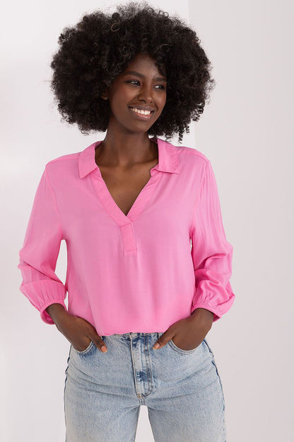 Elegant pink everyday blouse by Sublevel, featuring a heart neckline and pre-wrist sleeves, styled with light blue denim jeans for a chic casual look.